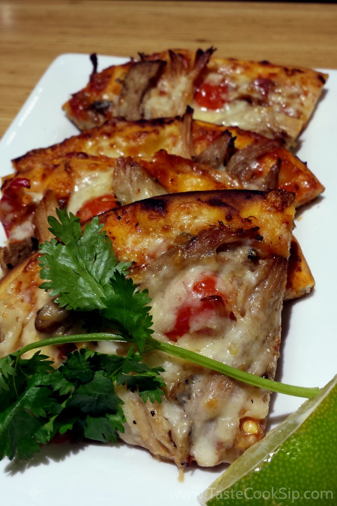 Pork Adobo Flatbread. Spicy Latin adobo flavors of cumin and fire-roasted tomatoes, naturally raised pork, cheese and Fresno peppers, toasted atop flatbread and finished with fresh lime and cilantro