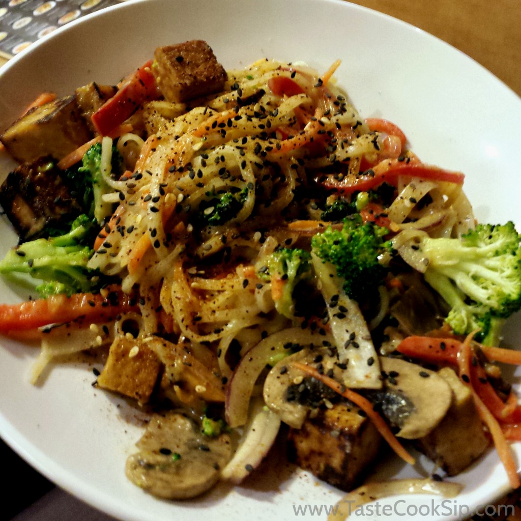 Indonesian Peanut Saute. Spicy peanut sauce and rice noodle stir-fry, broccoli, carrots, cabbage, Asian sprouts, cilantro, crushed peanuts and lime- added organic tofu.