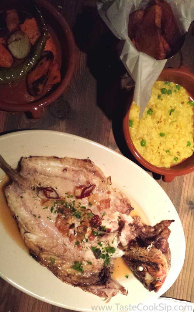 Pescado "Xixario", wood grilled whole fish with garlic chips, dried pepper and charred garden vegetables. Also pictured, side orders of Saffron risotto and Porcini salted fries.