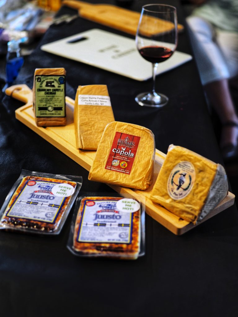 display of Wisconsin cheeses on Cheelandia board