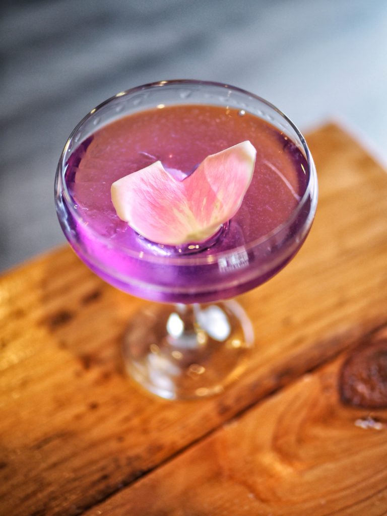 The Ol' Blue Eyes features Hendrick's Gin, St. Germaine, Rosewater drop, Lemon, Butterfly Pea Flower Extract, and a Violette rinse. 