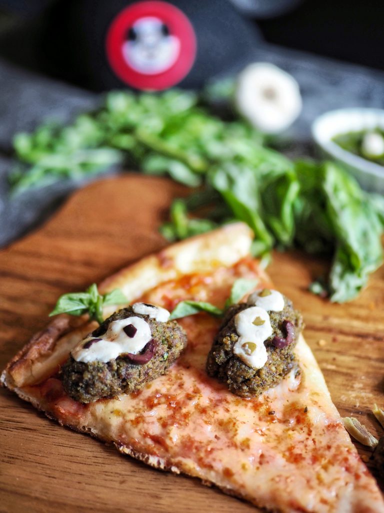 close up of alien meatballs with melted mozzarella eyeballs